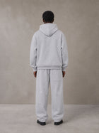 Model wearing the SM Track Line Hoodie and SM Track Line Sweatpants in Floral Grey, rear view.