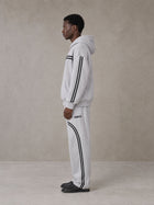Model wearing the SM Track Line Hoodie and SM Track Line Sweatpants in Floral Grey, side profile.