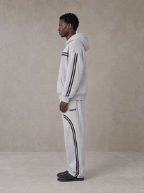 Model wearing the SM Track Line Hoodie and SM Track Line Sweatpants in Floral Grey, side profile.