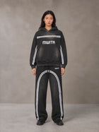 Model wearing the SM Track Line Hoodie and SM Track Line Sweatpants in Midnight Black, front view.