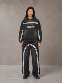 Model wearing the SM Track Line Hoodie and SM Track Line Sweatpants in Midnight Black, front view.