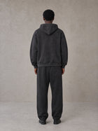 Model wearing the SM Track Line Hoodie and SM Track Line Sweatpants in Midnight Black, rear view.