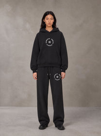 Model wearing the SM London Hoodie and SM London Sweatpants in Deep Charcoal, front view.