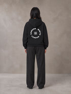 Model wearing the SM London Hoodie and SM London Sweatpants in Deep Charcoal, rear view.
