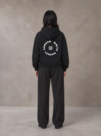 Model wearing the SM London Hoodie and SM London Sweatpants in Deep Charcoal, rear view.