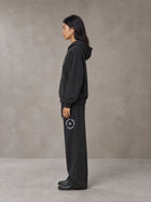 Model wearing the SM London Hoodie and SM London Sweatpants in Deep Charcoal, side profile.