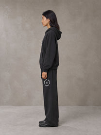 Model wearing the SM London Hoodie and SM London Sweatpants in Deep Charcoal, side profile.