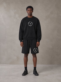 Model wearing the SM London Sweatshirt and SM London Shorts in Midnight Black, front view.