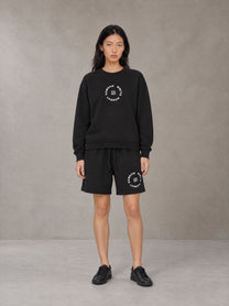 Model wearing the SM London Sweatshirt and SM London Shorts in Midnight Black, front view.