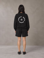 Model wearing the SM London Sweatshirt and SM London Shorts in Midnight Black, rear view.