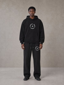 Model wearing the SM London Hoodie and SM London Sweatpants in Midnight Black, front view.