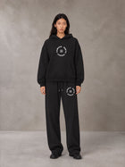 Model wearing the SM London Hoodie and SM London Sweatpants in Midnight Black, front view.