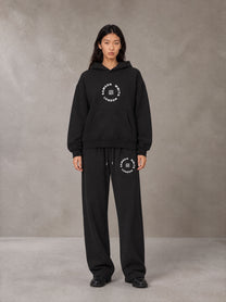 Model wearing the SM London Hoodie and SM London Sweatpants in Midnight Black, front view.