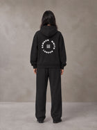 Model wearing the SM London Hoodie and SM London Sweatpants in Midnight Black, rear view.