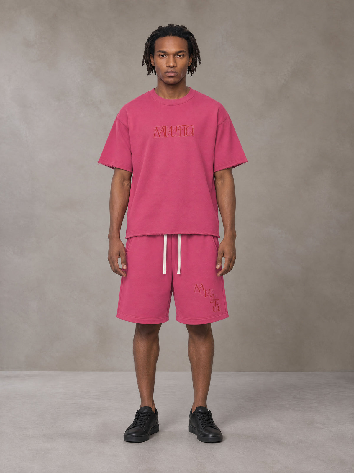 Model wearing the SM Echo Fleur T-shirt and SM Echo Fleur Shorts in Cherry Blush, front view.