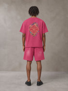 Model wearing the SM Echo Fleur T-shirt and SM Echo Fleur Shorts in Cherry Blush, rear view.