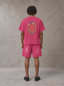 Model wearing the SM Echo Fleur T-shirt and SM Echo Fleur Shorts in Cherry Blush, rear view.