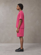 Model wearing the SM Echo Fleur T-shirt and SM Echo Fleur Shorts in Cherry Blush, side profile.