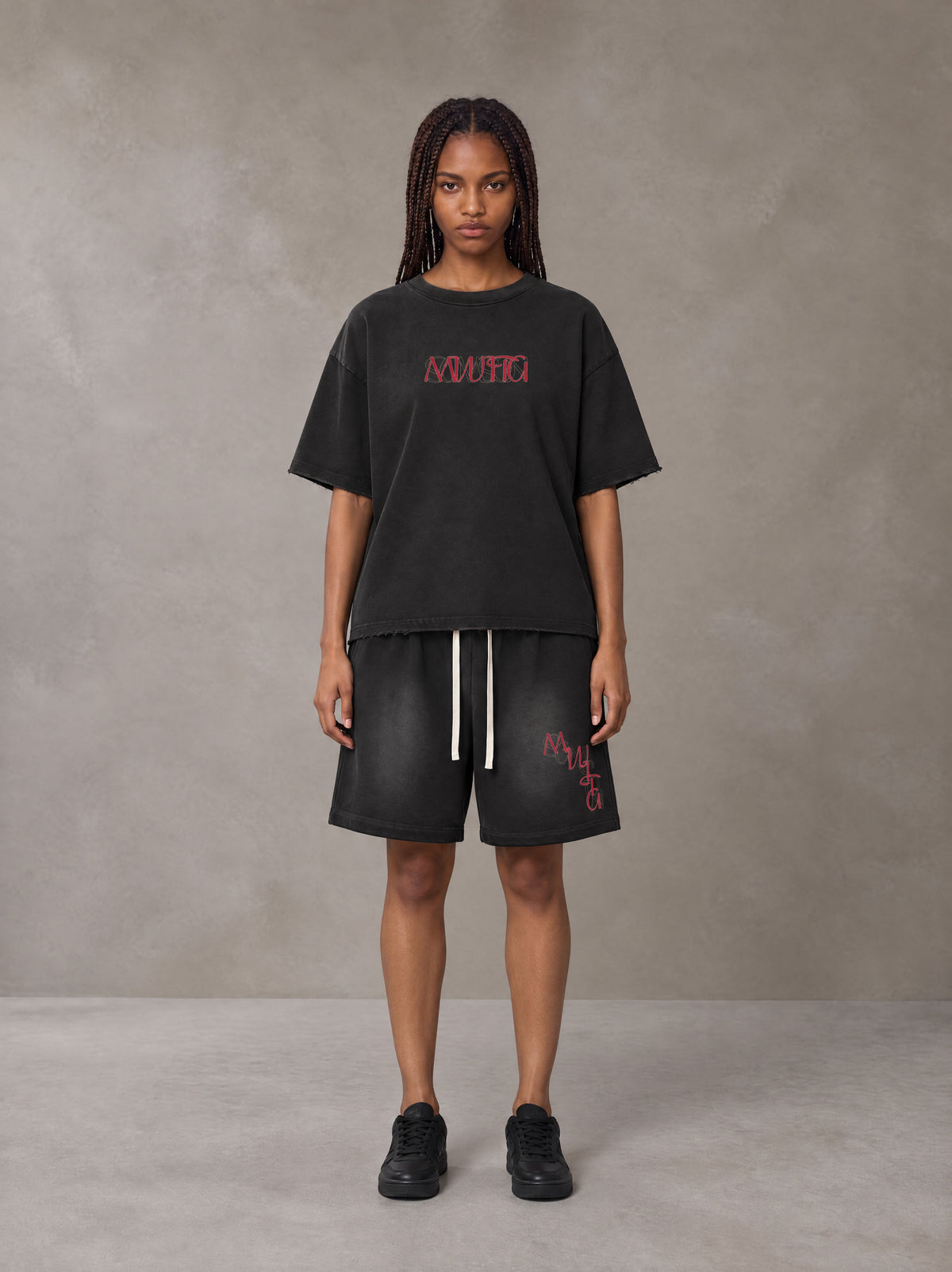 Model wearing the SM Echo Fleur T-shirt and SM Echo Fleur Shorts in Midnight Black, front view.