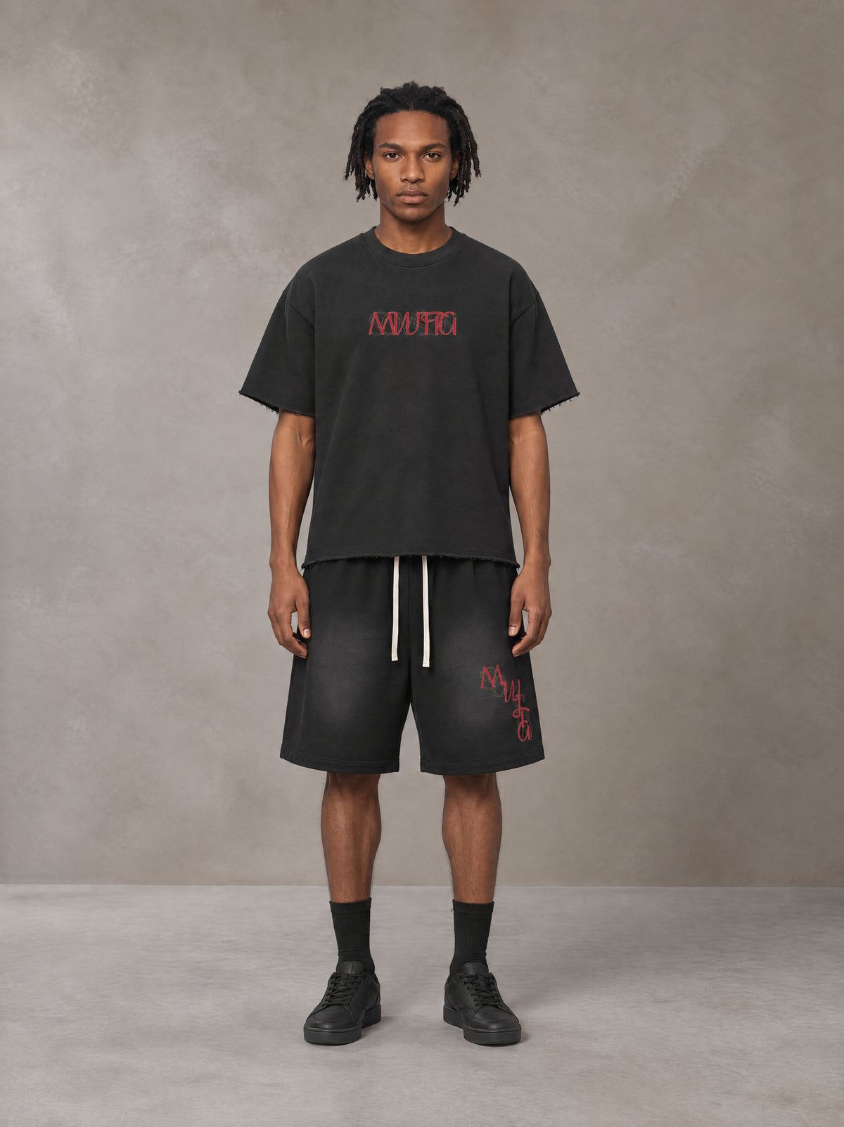 Model wearing the SM Echo Fleur T-shirt and SM Echo Fleur Shorts in Midnight Black, front view.