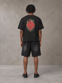 Model wearing the SM Echo Fleur T-shirt and SM Echo Fleur Shorts in Midnight Black, rear view.