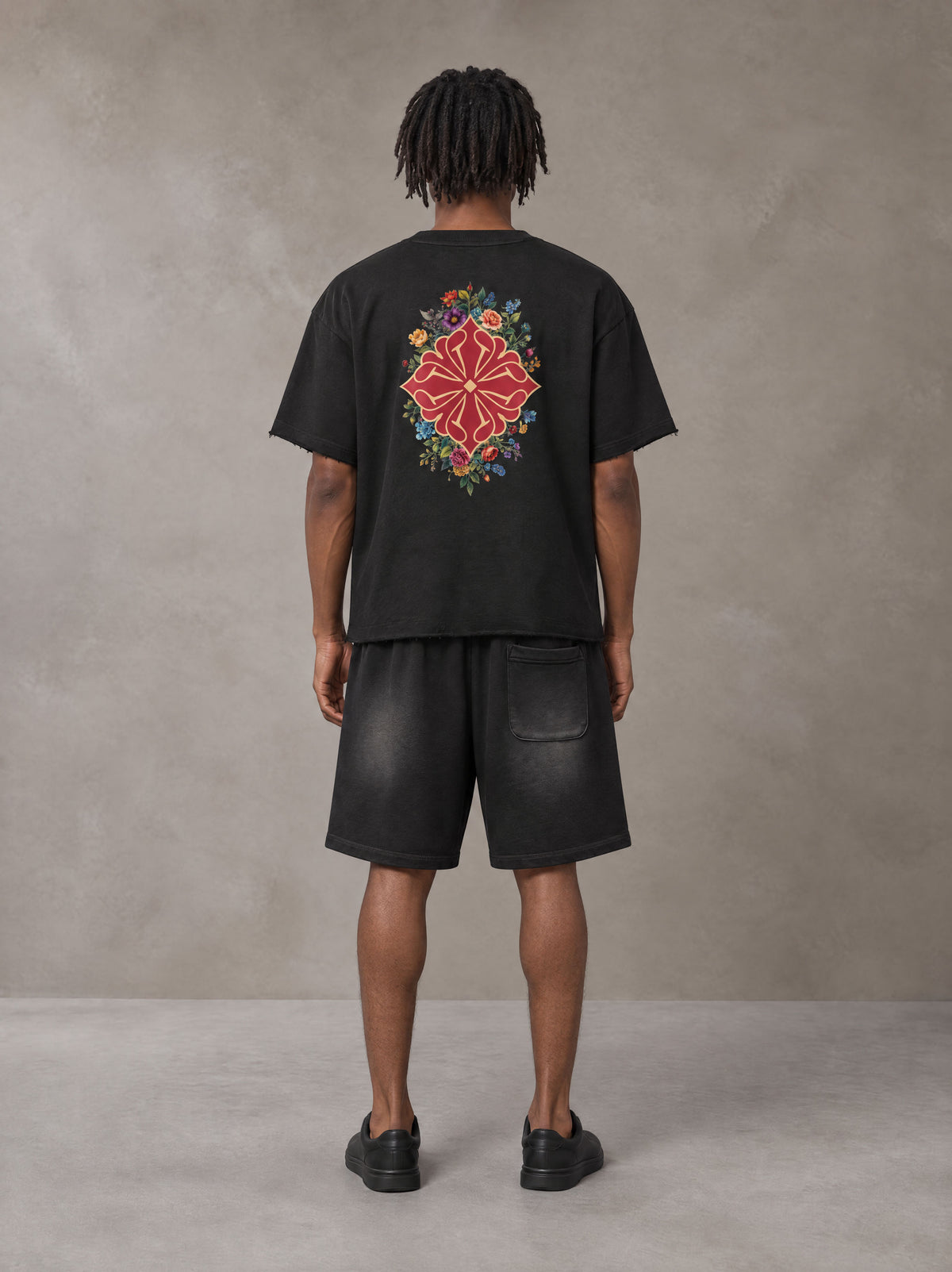 Model wearing the SM Echo Fleur T-shirt and SM Echo Fleur Shorts in Midnight Black, rear view.