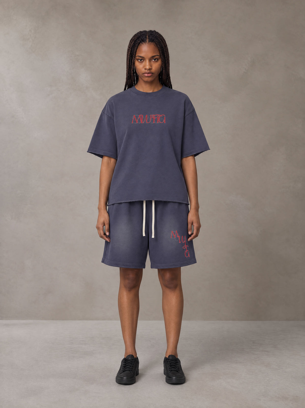 Model wearing the SM Echo Fleur T-shirt and SM Echo Fleur Shorts in Oxford Navy, front view.