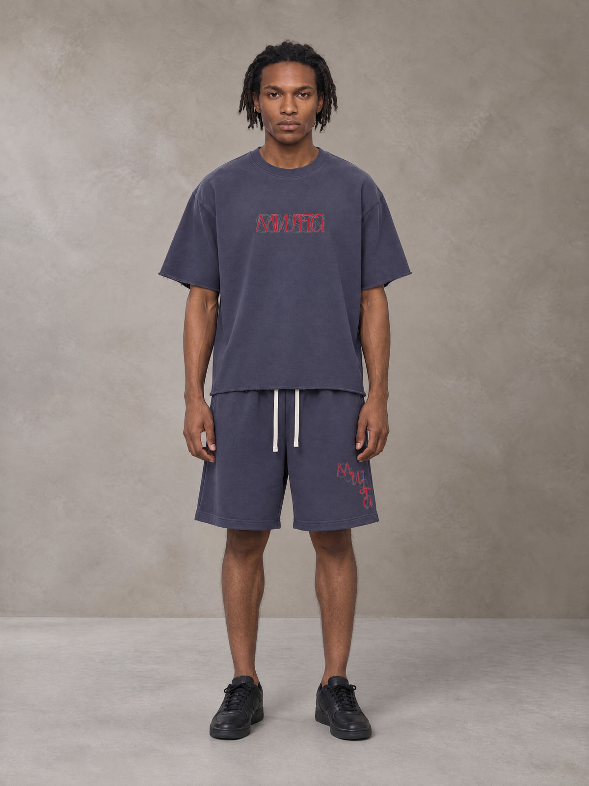 Model wearing the SM Echo Fleur T-shirt and SM Echo Fleur Shorts in Oxford Navy, front view.