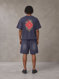 Model wearing the SM Echo Fleur T-shirt and SM Echo Fleur Shorts in Oxford Navy, rear view.