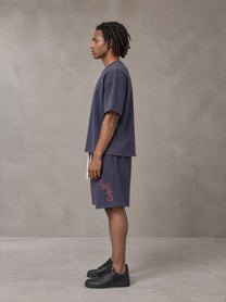 Model wearing the SM Echo Fleur T-shirt and SM Echo Fleur Shorts in Oxford Navy, side profile.