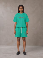 Model wearing the SM Echo Fleur T-shirt and SM Echo Fleur Shorts in Spring Shade, front view.