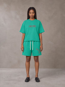Model wearing the SM Echo Fleur T-shirt and SM Echo Fleur Shorts in Spring Shade, front view.