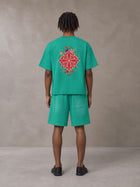 Model wearing the SM Echo Fleur T-shirt and SM Echo Fleur Shorts in Spring Shade, rear view.