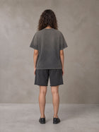 Model wearing the SM Vintage Washed T-shirt and SM Vintage Washed Shorts in Deep Charcoal, rear view.