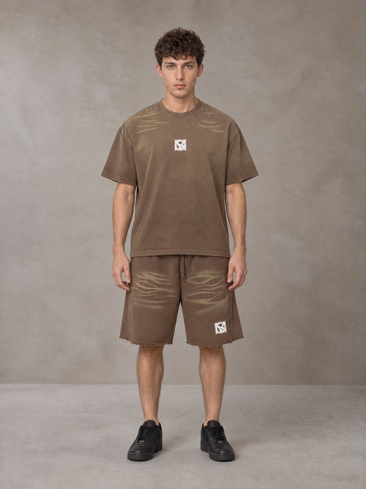 Model wearing the SM Vintage Washed T-shirt and SM Vintage Washed Shorts in Deep Coffee, front view.