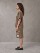 Model wearing the SM Vintage Washed T-shirt and SM Vintage Washed Shorts in Deep Coffee, side profile.