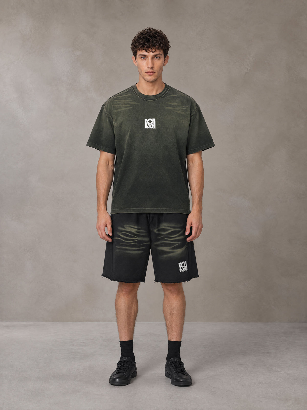 Model wearing the SM Vintage Washed T-shirt and SM Vintage Washed Shorts in Midnight Black, front view.
