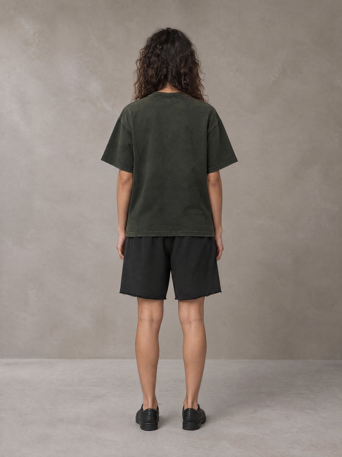 Model wearing the SM Vintage Washed T-shirt and SM Vintage Washed Shorts in Midnight Black, rear view.