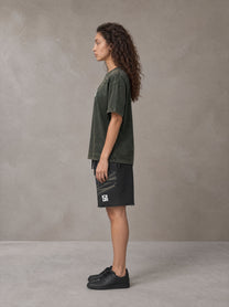 Model wearing the SM Vintage Washed T-shirt and SM Vintage Washed Shorts in Midnight Black, side profile.
