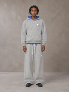 Model wearing the SM Sig. Plaid Zip Hoodie and SM Sig. Plaid Sweatpants in Floral Grey, front view.