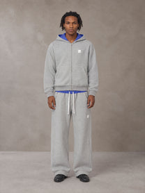 Model wearing the SM Sig. Plaid Zip Hoodie and SM Sig. Plaid Sweatpants in Floral Grey, front view.