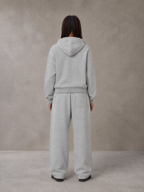 Model wearing the SM Sig. Plaid Zip Hoodie and SM Sig. Plaid Sweatpants in Floral Grey, rear view.