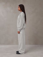 Model wearing the SM Sig. Plaid Zip Hoodie and SM Sig. Plaid Sweatpants in Floral Grey, side profile.
