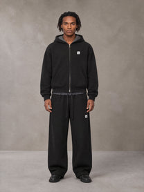 Model wearing the SM Sig. Plaid Zip Hoodie and SM Sig. Plaid Sweatpants in Midnight Black, front view.