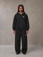 Model wearing the SM Sig. Plaid Zip Hoodie and SM Sig. Plaid Sweatpants in Midnight Black, front view.