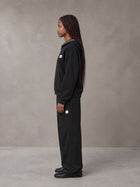 Model wearing the SM Sig. Plaid Zip Hoodie and SM Sig. Plaid Sweatpants in Midnight Black, side profile.