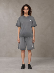 Model wearing the SM Sig. Reverse Dyed T-shirt and SM Sig. Reverse Dyed Shorts in Deep Charcoal, front view.
