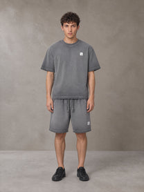 Model wearing the SM Sig. Reverse Dyed T-shirt and SM Sig. Reverse Dyed Shorts in Deep Charcoal, front view.