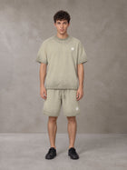 Model wearing the SM Sig. Reverse Dyed T-shirt and SM Sig. Reverse Dyed Shorts in Fine Sand, front view.