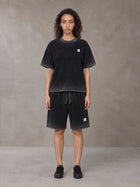 Model wearing the SM Sig. Reverse Dyed T-shirt and SM Sig. Reverse Dyed Shorts in Midnight Black, front view.